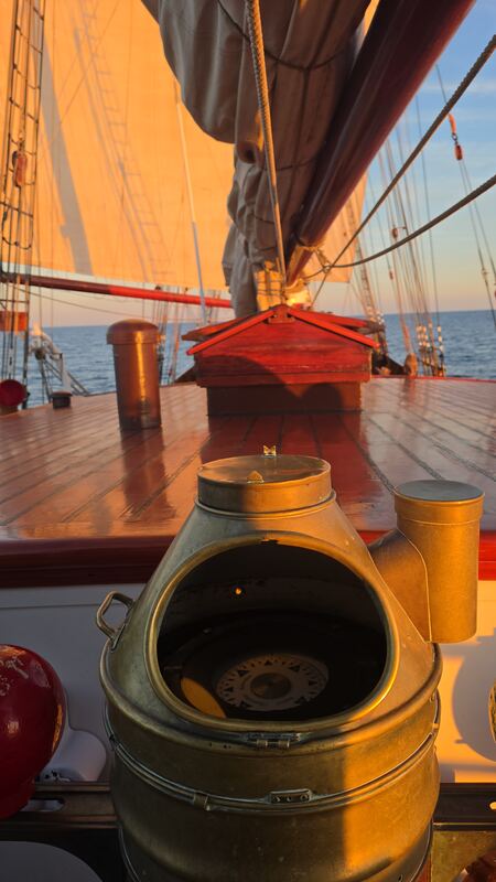 The brass binnacle at golden hour