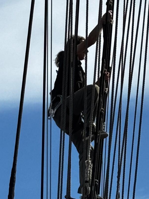Going aloft on the ratlines, clipped on