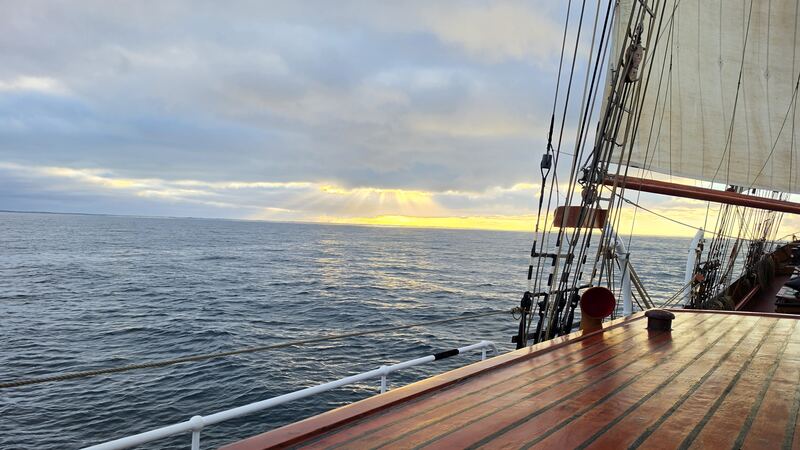 Sun breaking through over the swell